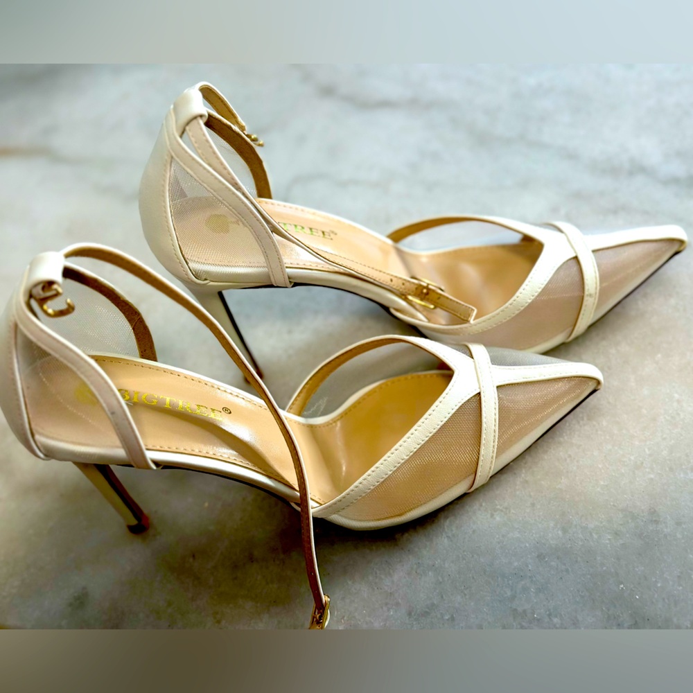 Women’s white pointed high heels.